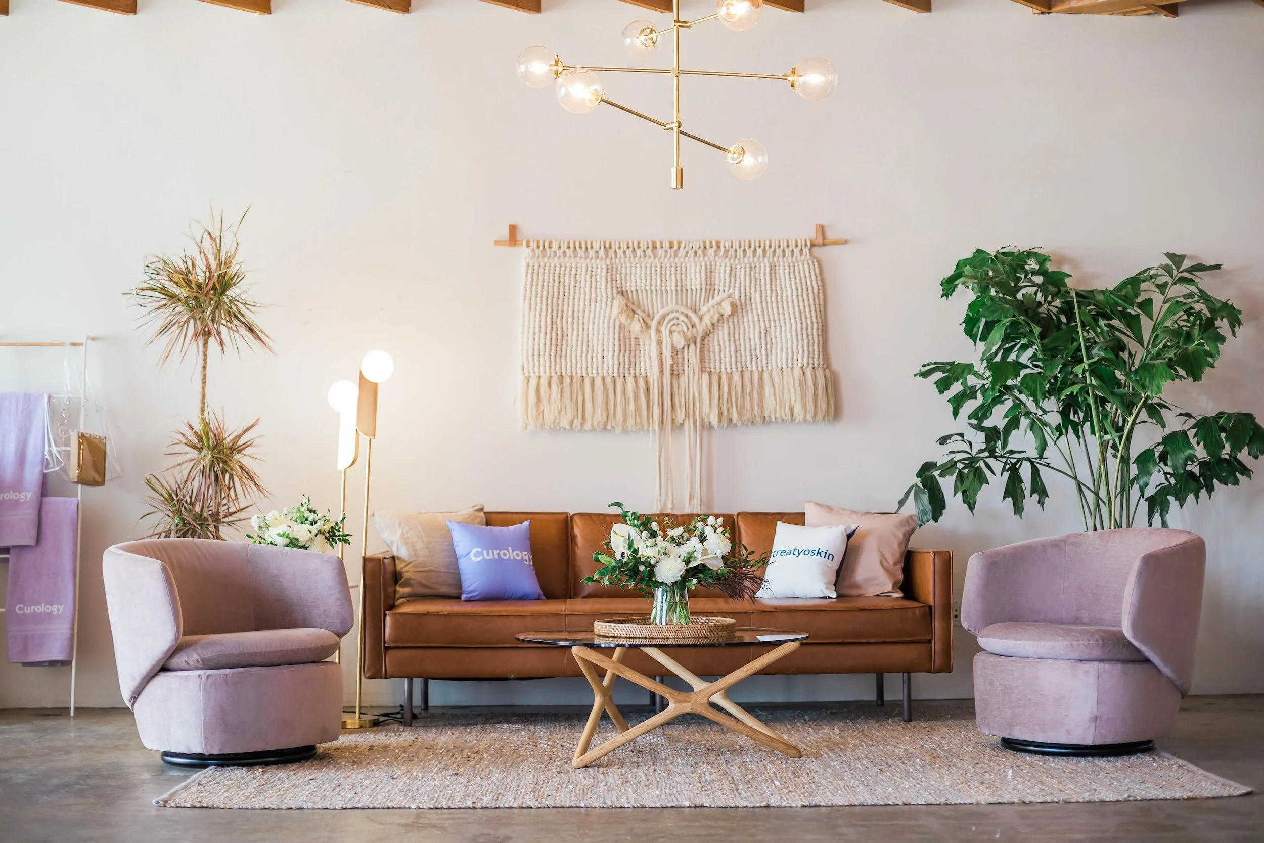 Living room with leather sofa, swivel chairs, and brass chandelier